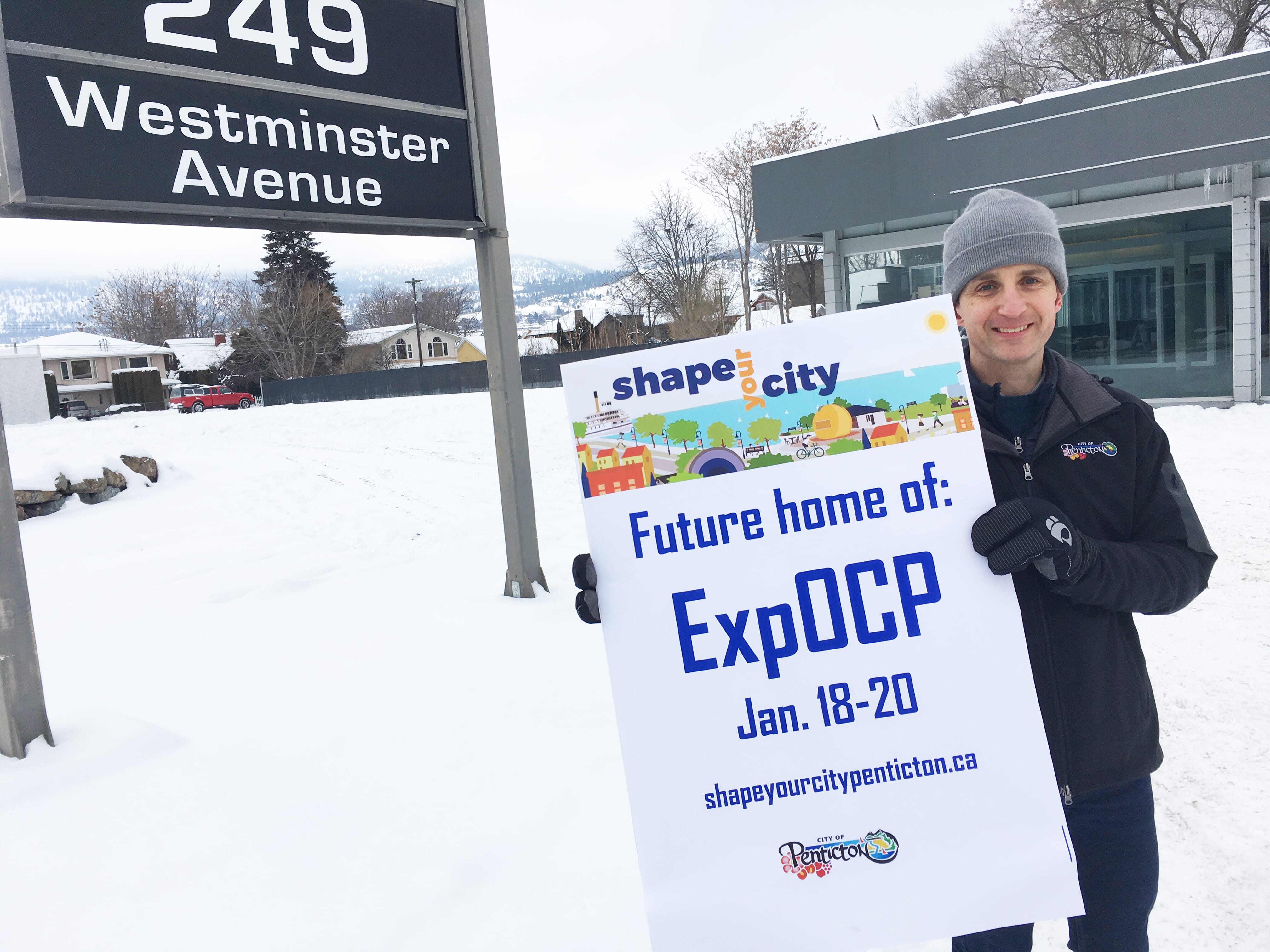 Man holding up Shape Your City sign