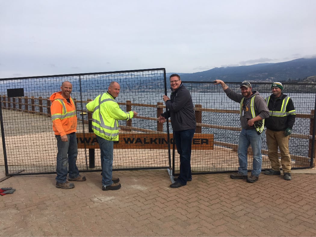 Workers removing fence on pier