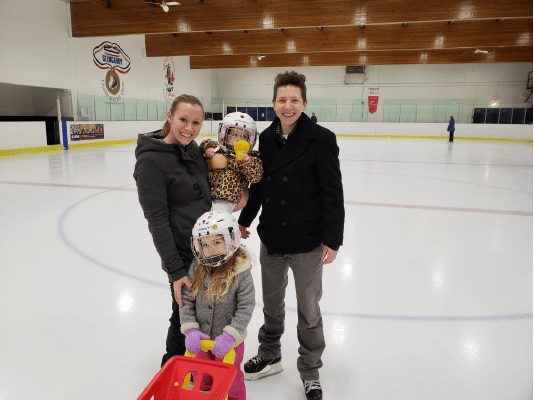 group standing on ice hockey rink