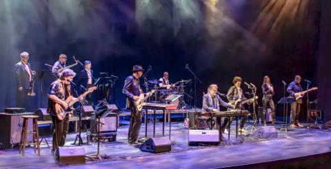 Musicians standing on stage during performance 