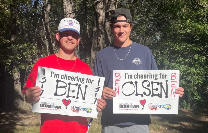 IRONMAN supporters waving the City of Penticton cheer signs.