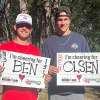 IRONMAN supporters waving the City of Penticton cheer signs.