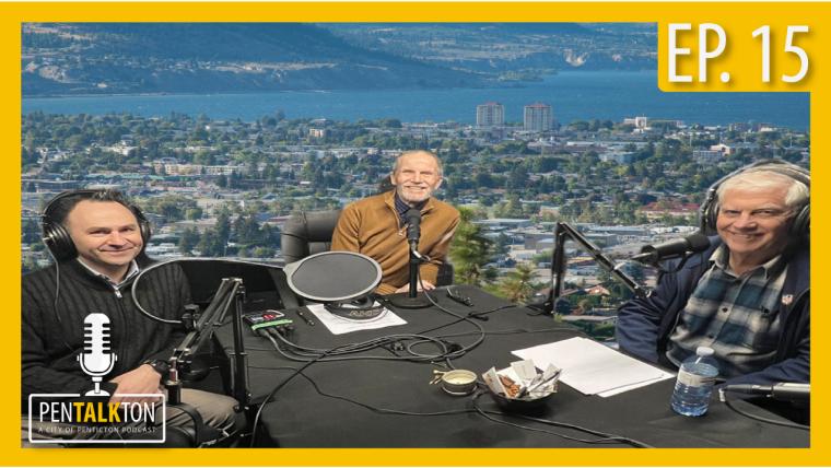 Three men sitting at a desk